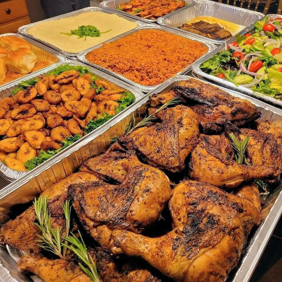 Roasted chicken with rice, plantains and salad buffet spread